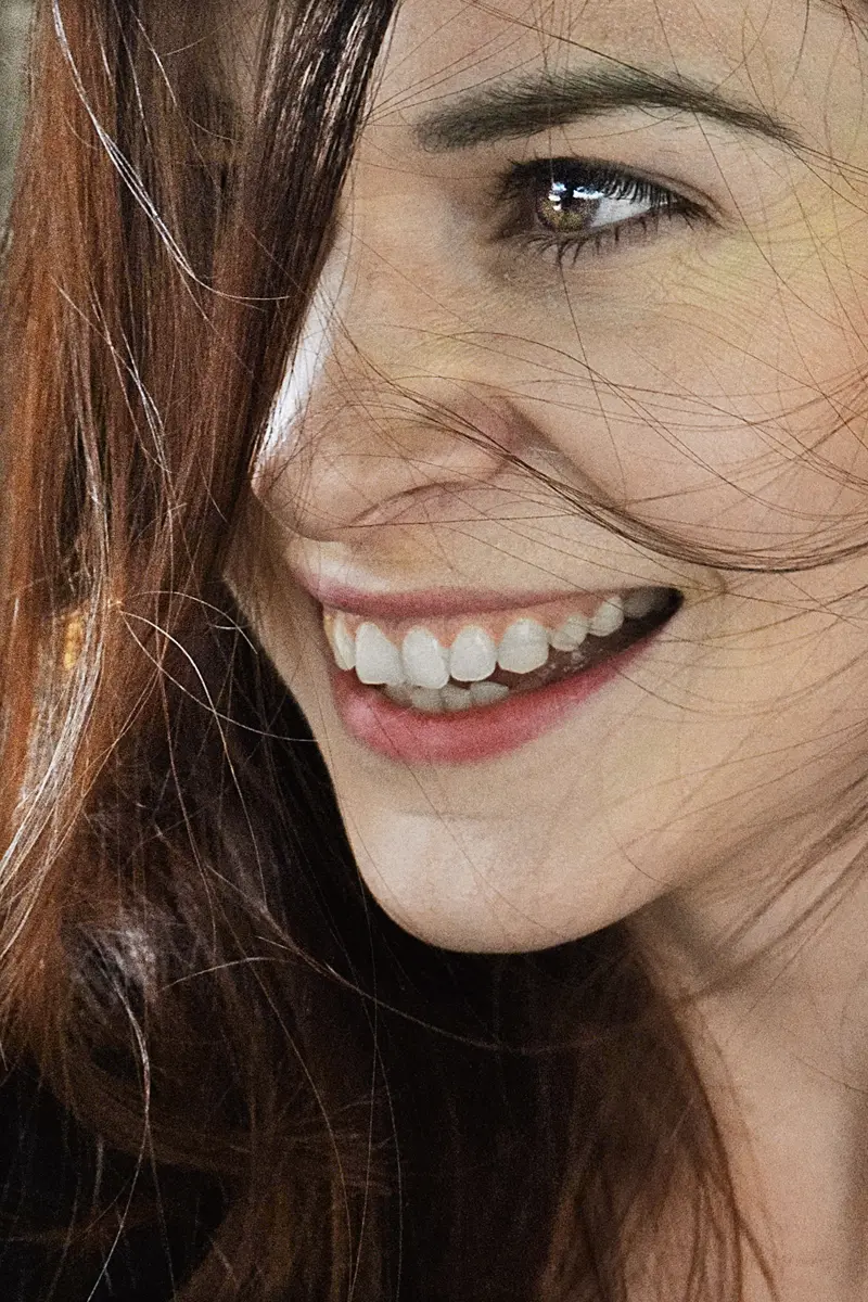 A patient smiling, teeth showing, after treatment.